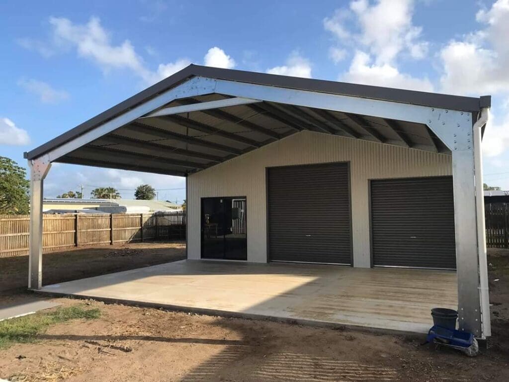 Completed shed home with carport and garage doors